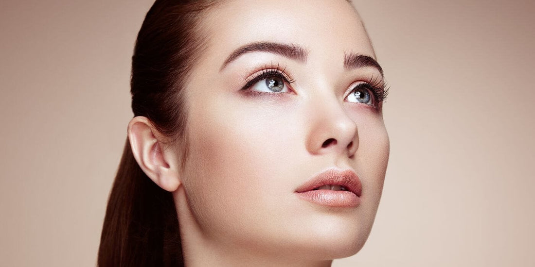 A well complexioned woman staring off into the distance.