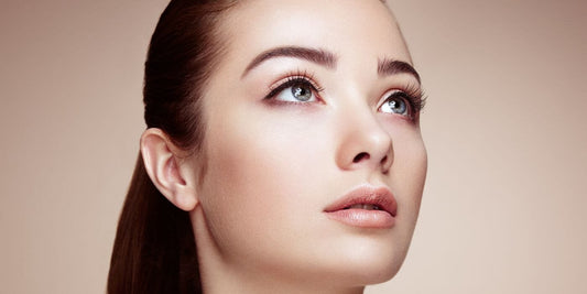 A well complexioned woman staring off into the distance. 