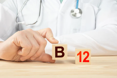 doctor holding a wooden block that says B forming B 12